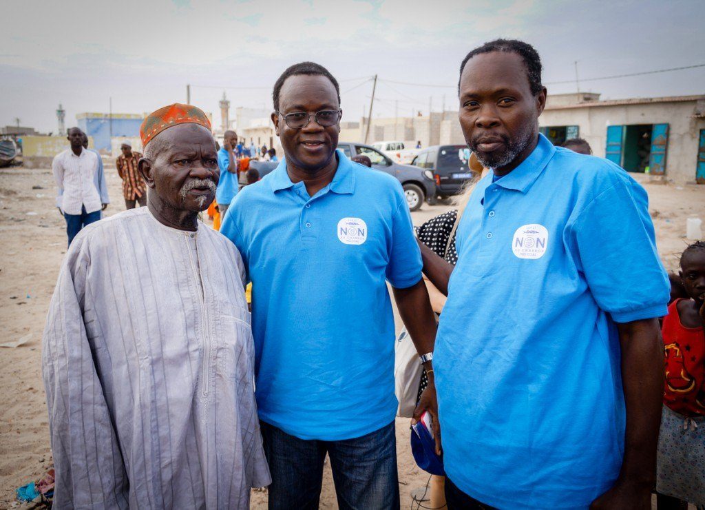 Bargny Coast Waterkeeper Fadel Wade (right) and Hann Baykeeper Mbacke Seck (center) consult with a religious leader from Bargny before the march for the climate. Organizing the march occurred largely through face-to-face meetings with village leaders who then convinced members of their communities to make the trip to Bargny.