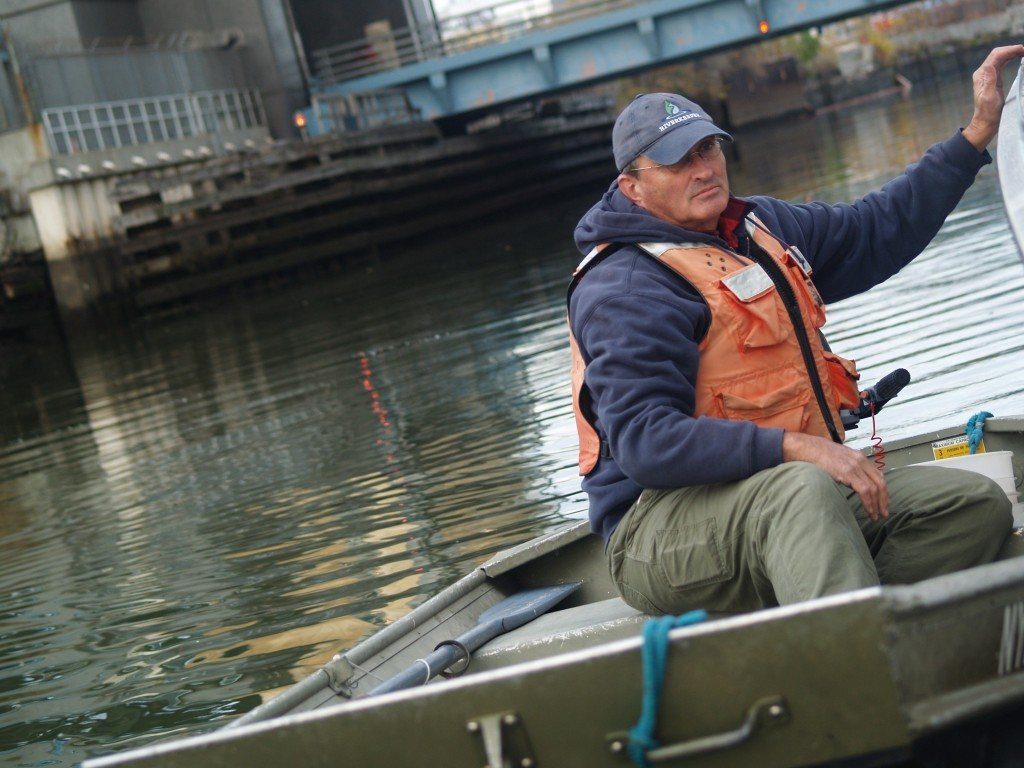Riverkeeper's boat captain John Lipscomb patrolling the Gowanus Canal in Brooklyn, NY.